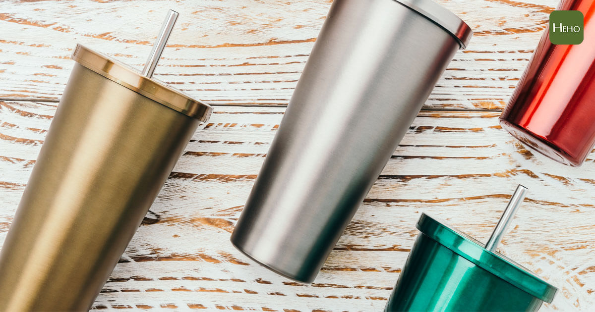 Stainless and tumbler cup on wooden background